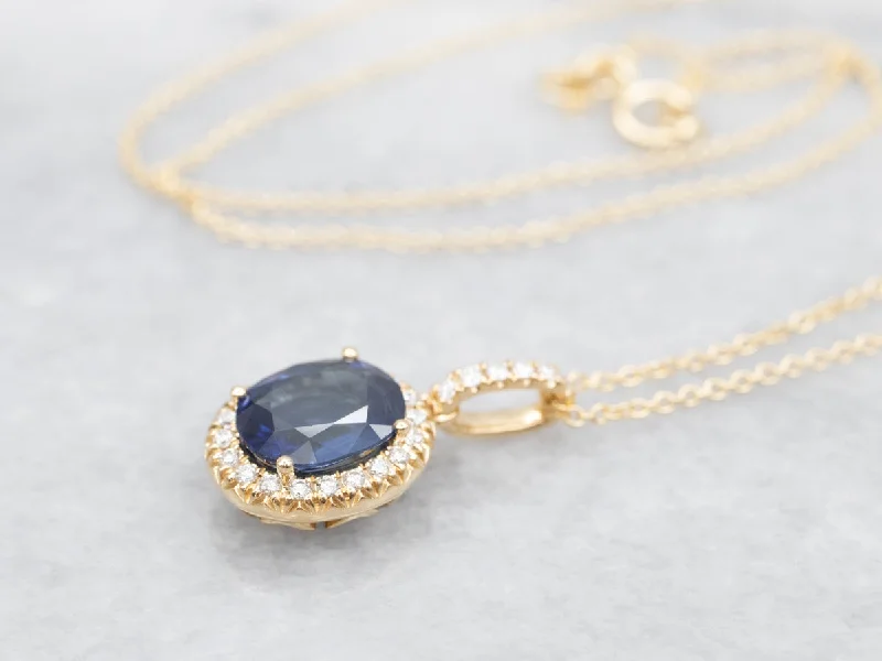 Ladies necklaces petite charm designs-Modern Gold Sapphire Halo Pendant Necklace